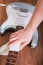 Guitar master polishing fretboard of electric guitar with cloth