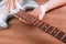 Guitar master polishing fretboard of electric guitar with cloth
