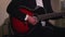 Guitar playing man, musical concert performance, red classical
