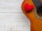 The guitar and red heart on white wooden texture background. Love, Music day concept.