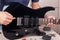 Guitar repairer adjusts scale on modern electric guitar