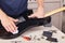 Guitar repairer wipes surface of modern electric guitar with rag