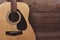 Guitar resting on old wooden background  Close up acoustic guitar - top view Musical instrument for recreation or hobby passion