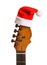Guitar with Santa hat on white. Christmas music concept