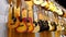 Guitar Shop. Lots of New Multicolored Acoustic Guitars are Hung in Music Store