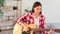 Guitar and singer concept, Young woman learning and practice playing chords with acoustic guitar