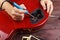 Guitar technician soldering electric guitar electronics in workplace