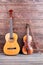 Guitar and violin on wooden background.