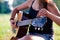 Guitarist adjusting tuning pegs