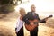 Guitarist and blonde girl standing on sandy beach