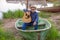 The guitarist of the country singer stands against the sky of the field. Rustic style. Summer vacation.