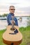 The guitarist of the country singer stands against the sky of the field. Rustic style. Summer vacation.