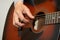 Guitarist hand, fingers playing acoustic guitar