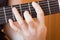 Guitarist hand playing acoustic guitar