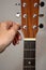 Guitarist hand tuning acoustic guitar