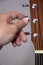 Guitarist hand tuning acoustic guitar