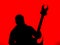 Guitarist with a Heavy Metal Pointed Guitar with Horned Headstock on Red Background