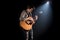 Guitarist, music. A young man plays an acoustic guitar on a black isolated background