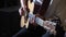 Guitarist playing acoustic guitar music on stage at rock concert indoors.