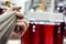 The guitarist`s hand, close-up and soft focus, takes the akrod on a guitar fretboard, against the background of the drum set.