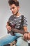 Guitarist in studio playing his instrument looking away