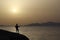 Guitarist at sunrise on the beach