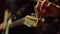 Guitarist turning knobs on fretboard in studio. Man holding guitar in hall.