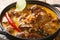 Gulai Kambing traditional Javanese mutton curry stew closeup on the wooden table. Horizontal