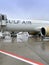 Gulf Air Bahrain airplane, turbine of plane on runway airport, wet from rain and snow, takeoff, landing of aircraft, concept