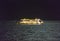 Gulf of Mexico - April 13, 2020: A Royal Caribbean cruise ship drifting in the Gulf of Mexico at night. Moon light reflecting off