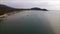 Gulf of Thailand`s coast aerial bird`s eye view, with the boat rolling on the placid sea