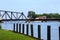 Gulls sit on Wooden Pilings in Front of St. Josephs` Swingbridge