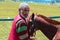 Gulmarg, Jammu and Kashmir- June 17 2019 : A Pony owner with his pony. Preparing for a ride