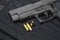 Gun and 9mm bullets on a bulletproof jacket