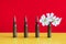 Gun cartridges on red yellow background close up. White flower in case. War and peace concept, hope concept. Spain and Warsaw