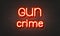Gun crime neon sign on brick wall background.