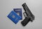 Gun with Ukrainian passports on grey background