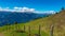 Gurglitzen - Wooden fence on alpine meadow with Panoramic view of mountain peaks of Karawanks and Julian Alps