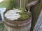 Gutter downspout with old wooden rain barrel and moss