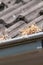 Gutter is full of grass and leaves, poor maintenance. Gutter should be cleaned by a plumber