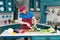 A Guy in apron preparing broccoli. chef cutting broccoli at home kitchen. A man cuts up fresh broccoli on a cutting board.