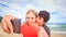 Guy Blond Girl Make Selfie Kiss Hide behind Red Heart on Beach