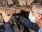 A guy a carpenter, a craftsman, selects wooden boards for and processing the blanks of his products. woodworking conceptn