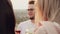 A guy of Caucasian appearance with a beard, glasses, standing on the Rooftop with his friends, drinking delicious