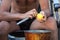 the guy cleans potatoes in a pot in nature camp. Hands close up