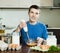 Guy cooking scrambled eggs for breakfast