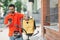 Guy courier in uniform, with beard, backpack looks at smartphone, holds bicycle and helmet