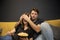guy covered girlfriend eyes his palms watching TV. bloody thriller Scary moment
