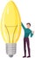 Guy creates idea of new project, planning startup. Man holding coffee to go stands near light bulb