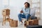 guy with curly hair sitting on a chair with boxes interior moving interior